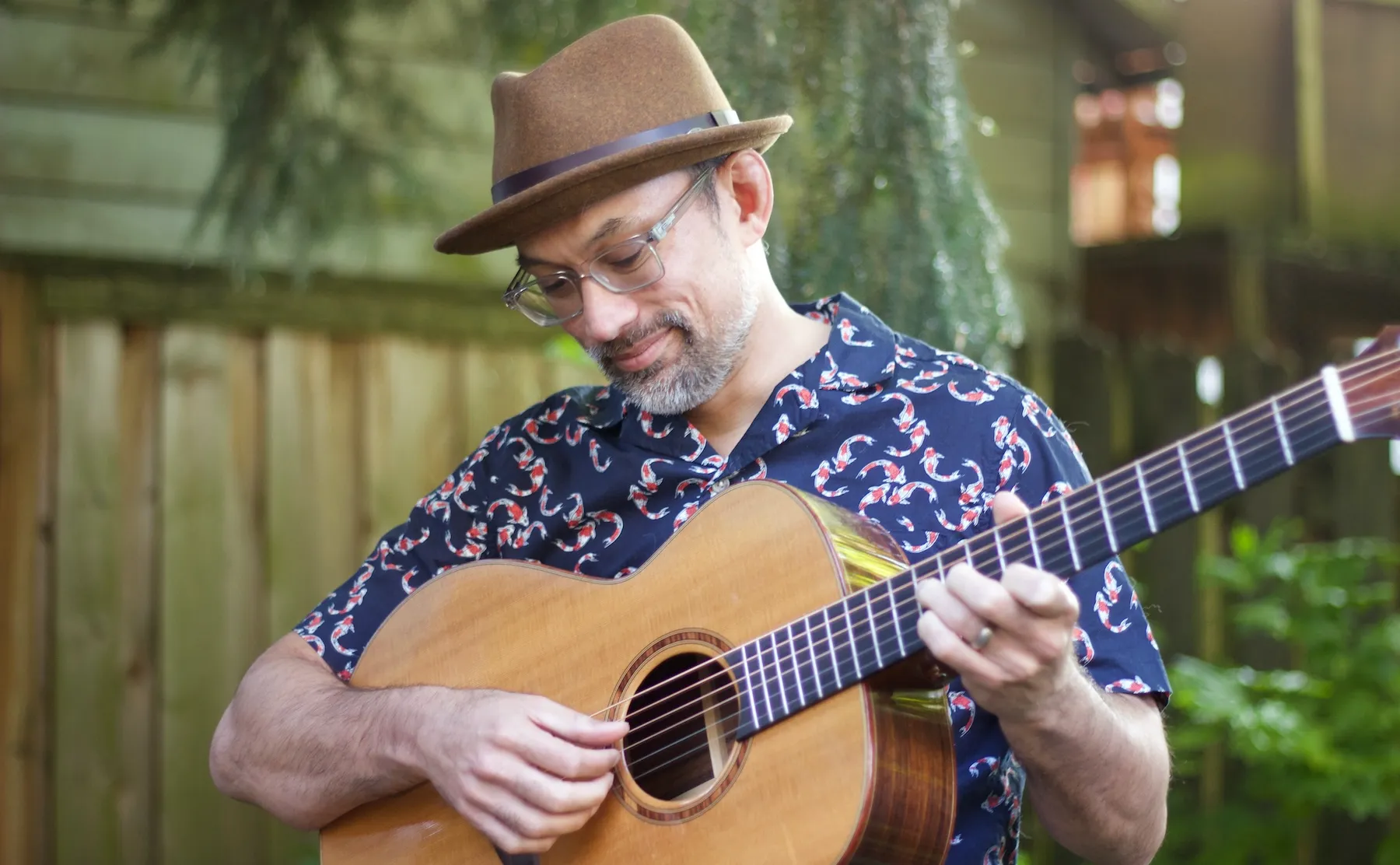 Anton playing guitar in the backyard